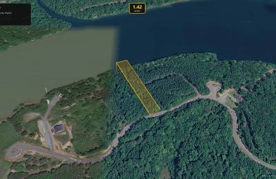 Vacant lot with paved road frontage, serene lake access and resort style amenities